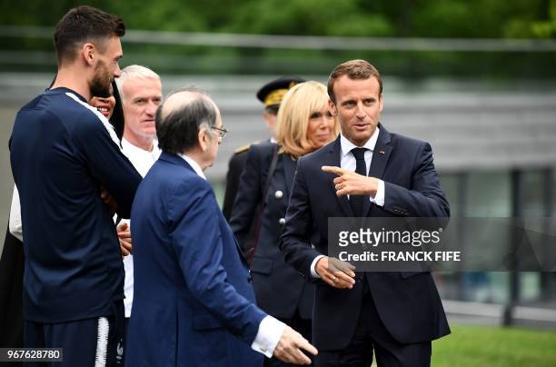France's national football team's head coach Didier Deschamps stands while French President Emmanuel Macron , flanked by his wife Brigitte Macron ,...