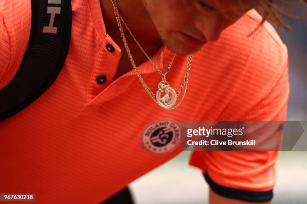 Detailed view of the necklace of Alexander Zverev of Germany packs his bag following defeat during the mens singles quarter finals match against...