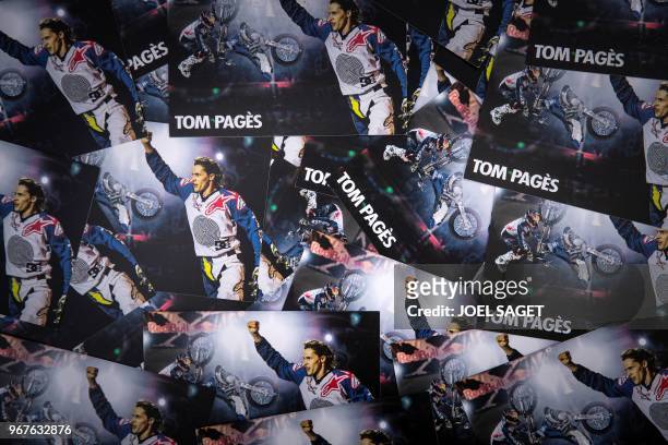 View of postcards showing french freestyle motocross rider and world champion Tom Pages in Barcelona on May 26, 2018.