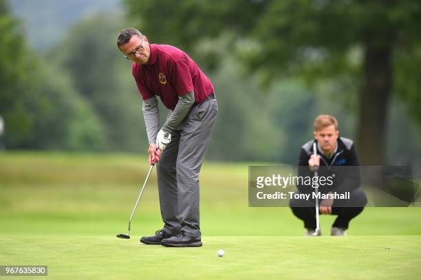 Luke Towler of Telford Golf and Country Club watches as Chris Aitchison of Telford Golf and Country Club putts on the 15th green during The Lombard...