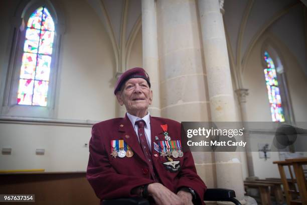 Ray Shuck who was a paratrooper on D-Day and was later shot in the head by a German sniper sits besides the pillar he was given the rites beside...