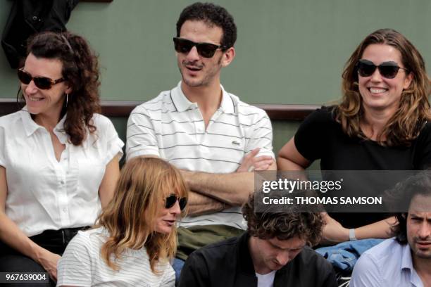 French actor Vincent Dedienne watches the men's singles quarter-final match between Austria's Dominic Thiem and Germany's Alexander Zverev on day ten...
