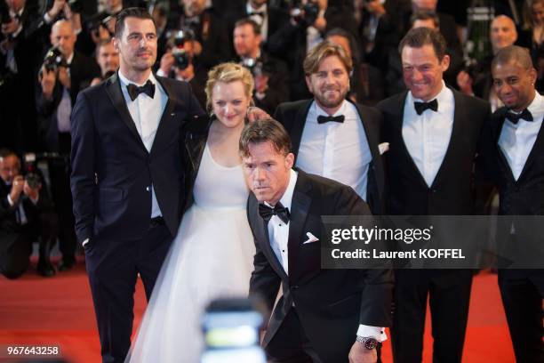 Dominic West, Elisabeth Moss, director Ruben Ostung, Claes Bang pose for pictures whilst actor Terry Notary imitates his character as they attend the...