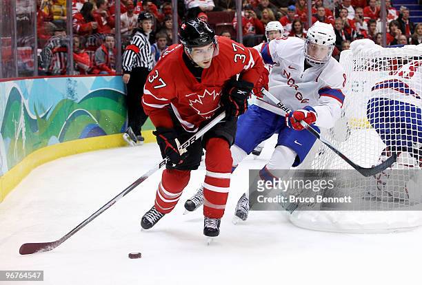 Patrice Bergeron of Canada skates with the puck against Mads Hansen of Norway during the ice hockey men's preliminary game between Canada and Norway...