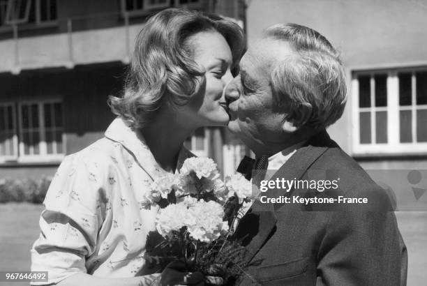 Austrian actor Hans Moser gives a grandfather s kiss to Romy Schneider in June 15,1959.