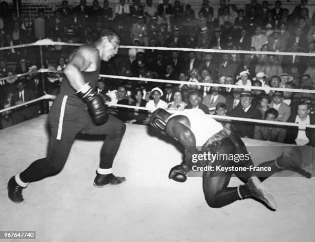 Le boxeur italien poids lourd envoie au tapis son partenaire Willie McGee lors d'un entraînement sur le ring le 17 juin 1935 à Owasco lake, NY.