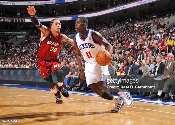 Jrue Holiday of the Philadelphia 76ers drives the ball against Michael Beasley of the Miami Heat during the game on February 16, 2010 at the Wachovia...