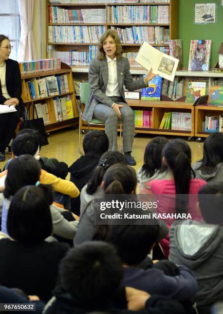 New US ambassador to Japan Caroline Kennedy reads a book to school children during her visit at Mangokura elementary school on November 25, 2013 in...