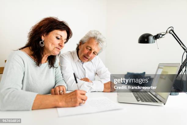 family working on financial issue at home - fazer um favor imagens e fotografias de stock
