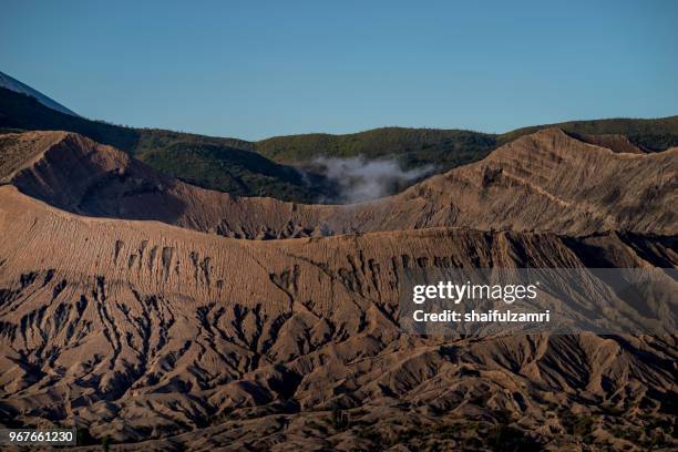 beautiful view landscape of active volcano crater with smoke at mt. bromo, east java, indonesia. - shaifulzamri - fotografias e filmes do acervo