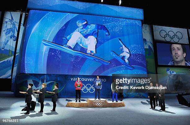 Mike Robertson of Canada celebrates winning the silver medal, Seth Wescott of the United States gold and Tony Ramoin of France bronze during the...