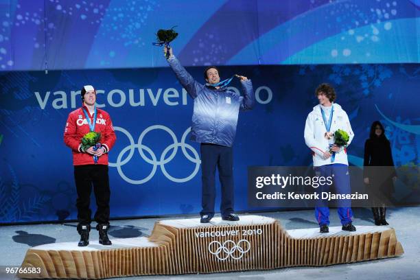 Mike Robertson of Canada celebrates winning the silver medal, Seth Wescott of the United States gold and Tony Ramoin of France bronze during the...