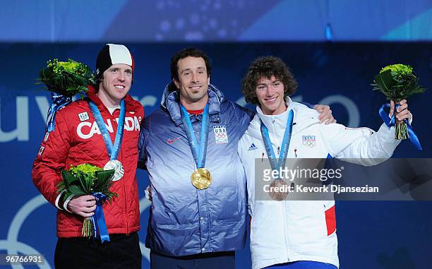 Mike Robertson of Canada celebrates winning the silver medal, Seth Wescott of the United States gold and Tony Ramoin of France bronze during the...