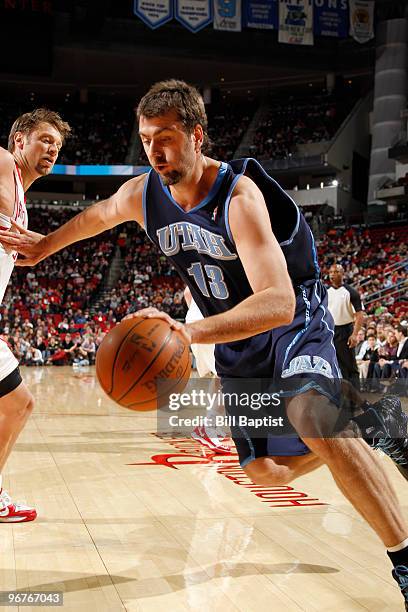 Mehmet Okur of the Utah Jazz drives the ball past David Anderson of the Houston Rockets on February 16, 2010 at the Toyota Center in Houston, Texas....