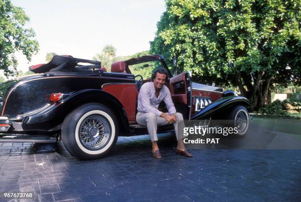 Julio Iglesias et sa voiture ancienne de collection le 23 juillet 1982 en France.