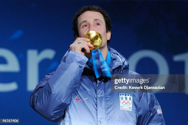 Seth Wescott of the United States kisses celebrates winning the gold medal during the medal ceremony the Men's Snowboard Cross on day 5 of the...