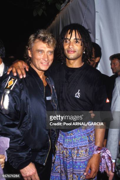 Johnny Hallyday et Yannick Noah lors de la fête de la musique le 21 juin 1991 à Paris, France.