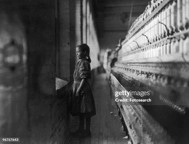 Photograph of a Young Girl Working in a Textile Mill by Lewis Hine, circa 1912.