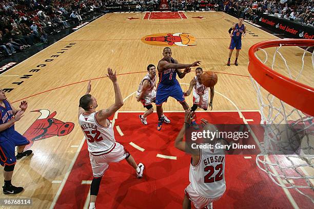 Chris Duhon of the New York Knicks passes against Brad Miller, Kirk Hinrich, Taj Gibson and Derrick Rose of the Chicago Bulls on February 16, 2010 at...