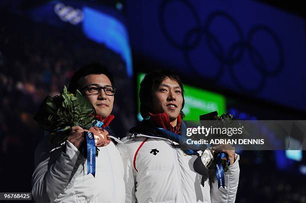 Japan's silver medalist Keiichiro Nagashima and Japan's bronze medalist Joji Kato pose during the medal ceremony of the men's Speed Skating 500...