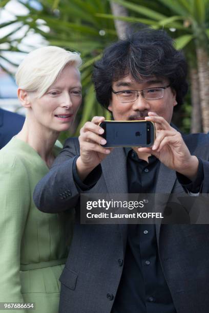 Tilda Swinton and director Bong Joon-Ho attend the 'Okja' Photocall during the 70th annual Cannes Film Festival at Palais des Festivals on May 19,...