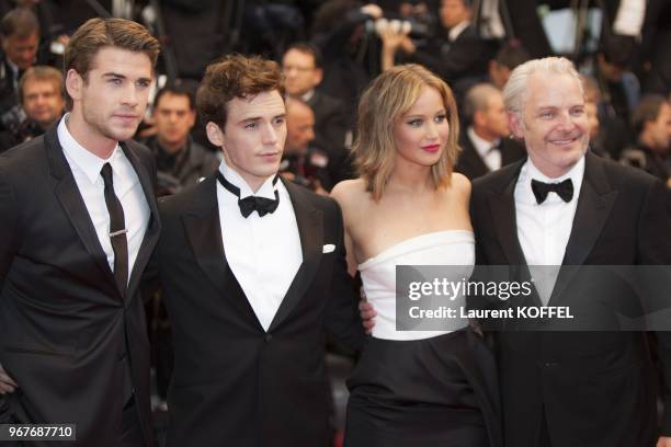 Director Francis Lawrence, Jennifer Lawrence, Sam Claflin and Liam Hemsworth attend the Premiere of 'Jimmy P. ' at Palais des Festivals during The...