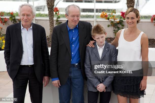 Jean Pierre, Thomas Doret, Cecile de France and Luc Dardenne pose at the "Le Gamin Au Velo" Portrait Session during the 64th Annual Cannes Film...