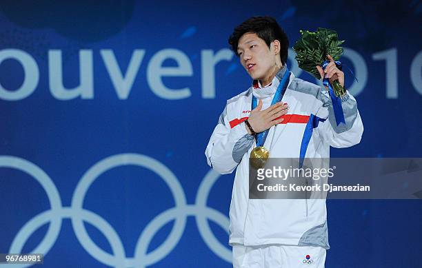 Mo Tae-Bum of South Korea stands for the playing of the National Anthem of South Korea as he celebrates winning the gold medal during the medal...