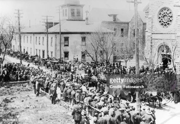 Photograph of Conclusion of Memorial Service of the Ludlow Massacre with Coffins being Placed on Wagons, Trinidad, Colorado. Circa April 1914.