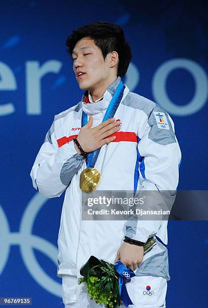 Mo Tae-Bum of South Korea stands for the playing of the National Anthem of South Korea as he celebrates winning the gold medal during the medal...