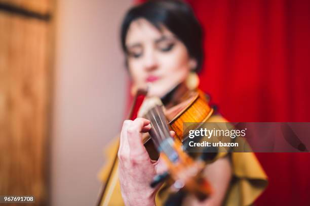 young and beautiful woman artist playing the violin on the stage. - soloist stock pictures, royalty-free photos & images