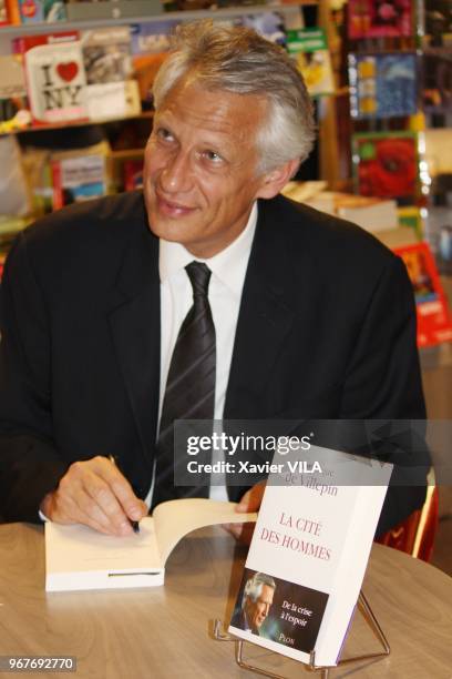 Former French Prime Minister Dominique de Villepin signing copies of his book "La cite des hommes" in a bookstore on June 09 in Lyon, France.