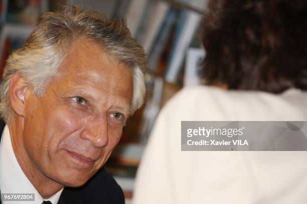 Former French Prime Minister Dominique de Villepin signing copies of his book "La cite des hommes" in a bookstore on June 09 in Lyon, France.