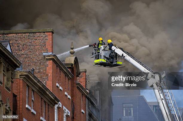 british firemen in action (close) - extinguishing 個照片及圖片檔