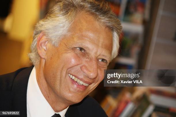 Former French Prime Minister Dominique de Villepin signing copies of his book "La cite des hommes" in a bookstore on June 09 in Lyon, France.