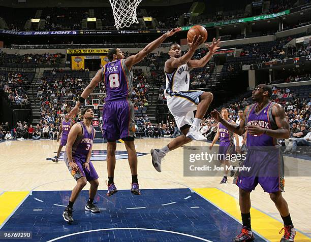 Sam Young of the Memphis Grizzlies shoots a layup against Channing Frye and Amar'e Stoudemire of the Phoenix Suns on February 16, 2010 at FedExForum...