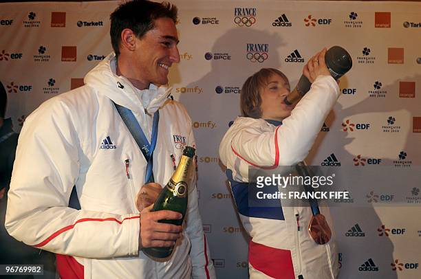 Biathlon French athletes Marie Laure Brunet and Vincent Jay drink Champagne as they celebrate the bronze medals of the Vancouver 2010 Winter Olympics...