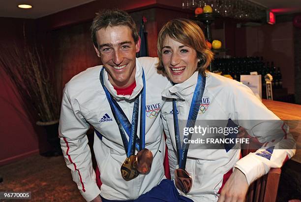 Biathlon French athletes Marie Laure Brunet and Vincent Jay pose with the bronze medals of the Vancouver 2010 Winter Olympics they won earlier in the...