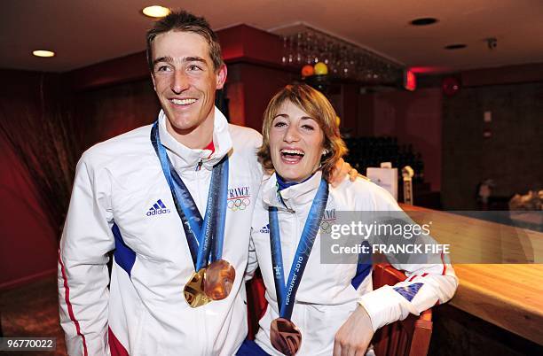 Biathlon French athletes Marie Laure Brunet and Vincent Jay pose with the bronze medals of the Vancouver 2010 Winter Olympics they won earlier in the...