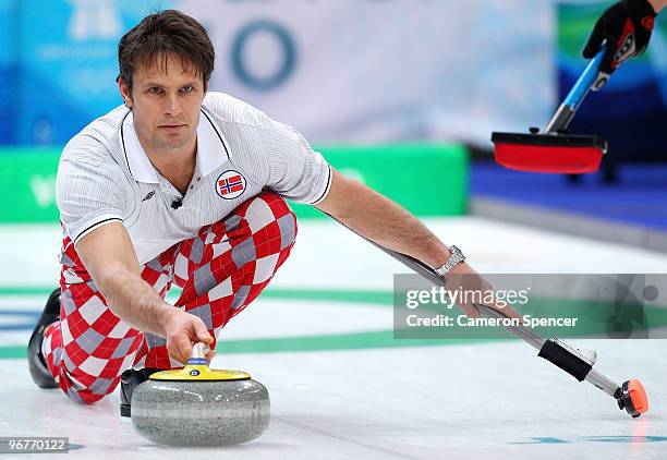 Skip Thomas Ulsrud of Norway releases his stone down the sheet during the men's curling round robin game between Norway and the United States on day...