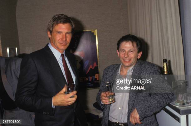 Harrison Ford et Roman Polanski lors d'un cocktail à Paris le 28 janvier 1988, France.