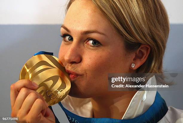 Magdalena Neuner of Germany poses with the gold medal for the Women's Biathlon 10km Pursuit on day 5 at the German house on February 16, 2010 in...