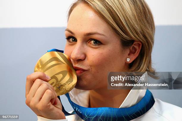 Magdalena Neuner of Germany poses with the gold medal for the Women's Biathlon 10km Pursuit on day 5 at the German house on February 16, 2010 in...