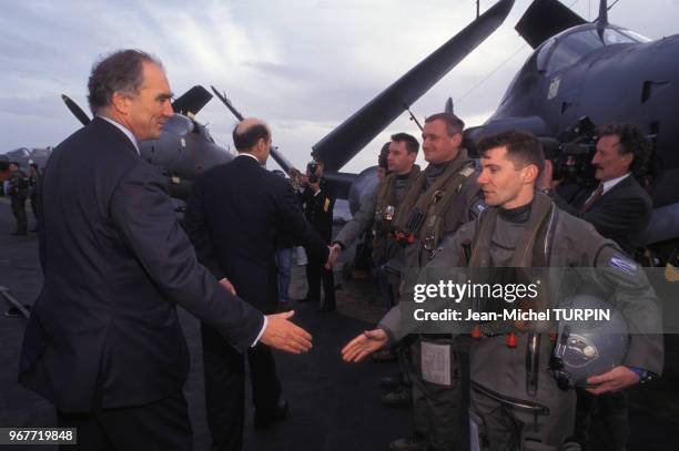 Charles Millon srre la main d'un pilote lors de la visite d'Alain Juppé sur le porte-avions Clémenceau le 25 janvier 1996, France.