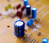 electrolytic capacitor on printed circuit board, macro, selective focus