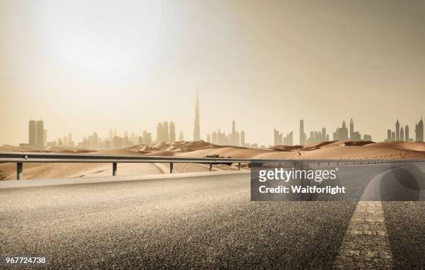 empty road with dubai skyline background - dubai road stock pictures, royalty-free photos & images