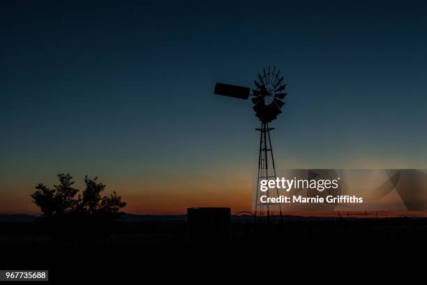 windmill at sunset - outback windmill stock pictures, royalty-free photos & images