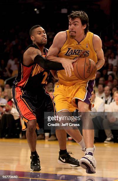 Adam Morrison of the Los Angeles Lakers drives to the basket while being defended by C.J. Watson of the Golden State Warriors in the first half at...