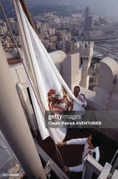 Les carabiniers hissent le drapeau monégasque le 21 juin 1989 à Monaco.