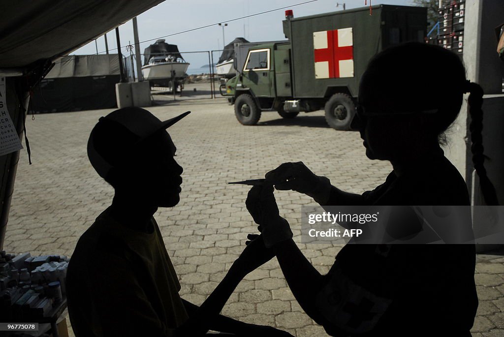 A Canadian marine nurse tends to a haiti
